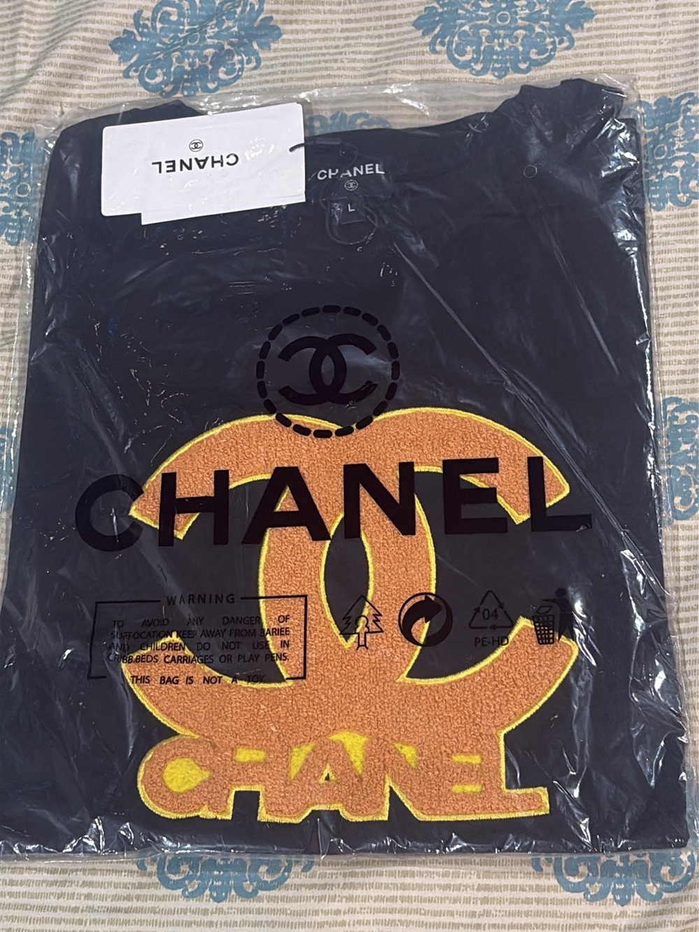 CHANEL Men’s Black Short Sleeve Tee with Yellow Logo Patch